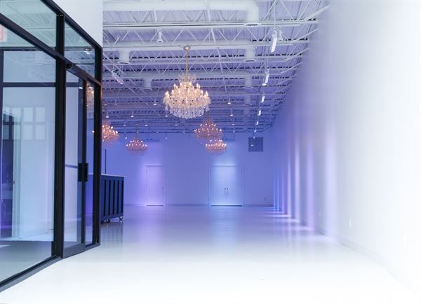 All white venue with stunning chandeliers