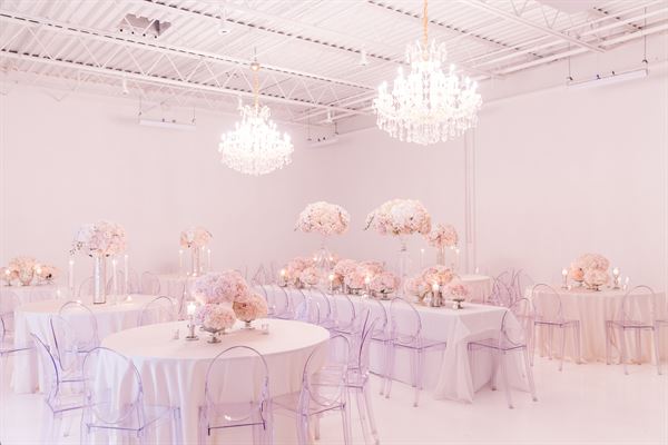 All white venue with stunning chandeliers