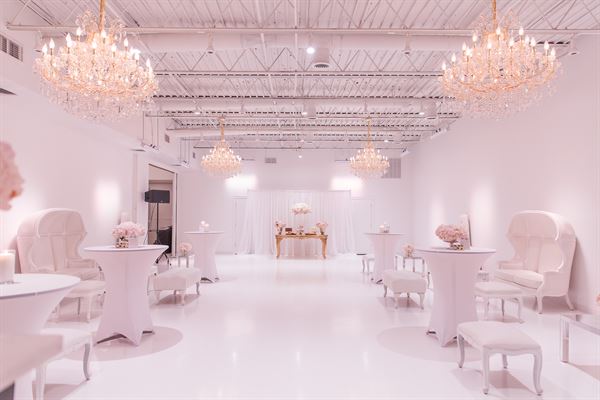 All white venue with stunning chandeliers